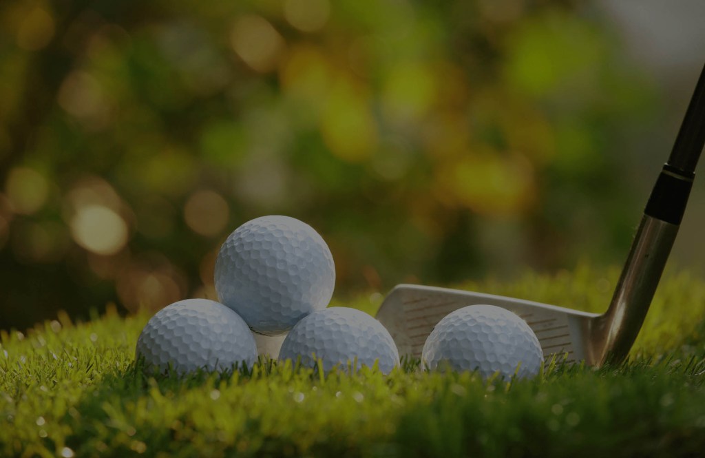 close up of golf club against a golf ball